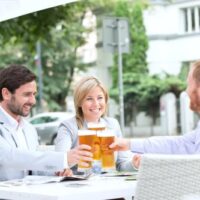 two men and a woman drinking beer