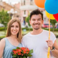 couple with baloons and flowers for their 3rd