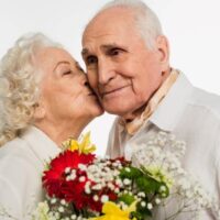 woman kissing husband on cheek on 70th anniversary