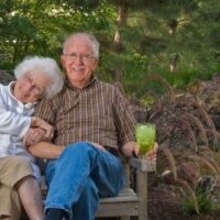 elderly couple on bench celebrating 75th